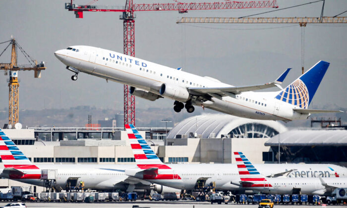 A United Airlines plane takes off above American Airlines planes on the tarmac at Los Angeles International Airport (LAX) in Los Angeles, Calif., on Oct. 1, 2020. (Mario Tama/Getty Images)