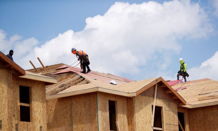 Carpenters work on building new townhomes that are still under construction while building material supplies are in high demand in Tampa, Fla., on May 5, 2021. (Octavio Jones/Reuters)