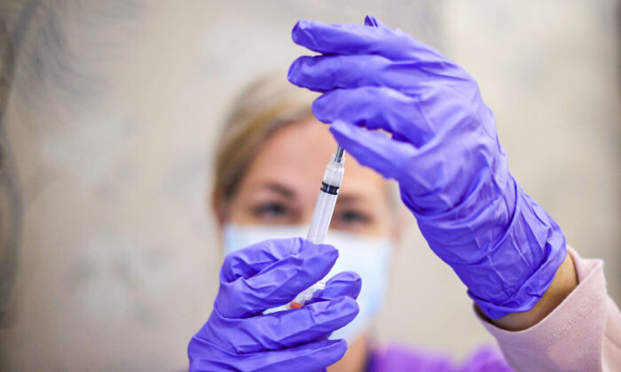 A nurse draws a vaccine dose from a vial in Bowie, Md., on March 25, 2021. (Win McNamee/Getty Images)