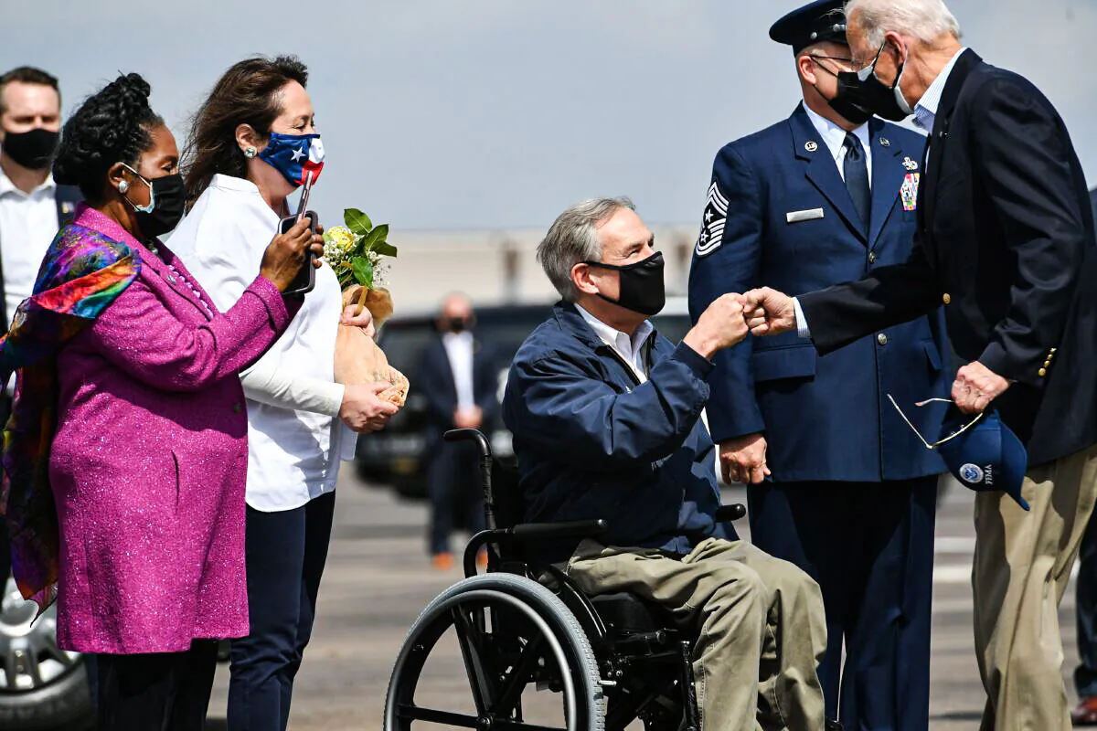 President Joe Biden (R) greets Texas Governor Greg Abbott and his wife Cecilia Abbott (2nd L) at Ellington Field Joint Reserve Base in Houston, Texas, on Feb. 26, 2021. Also welcoming the president is Rep. Sheila Jackson Lee (L). (MANDEL NGAN/AFP via Getty Images)