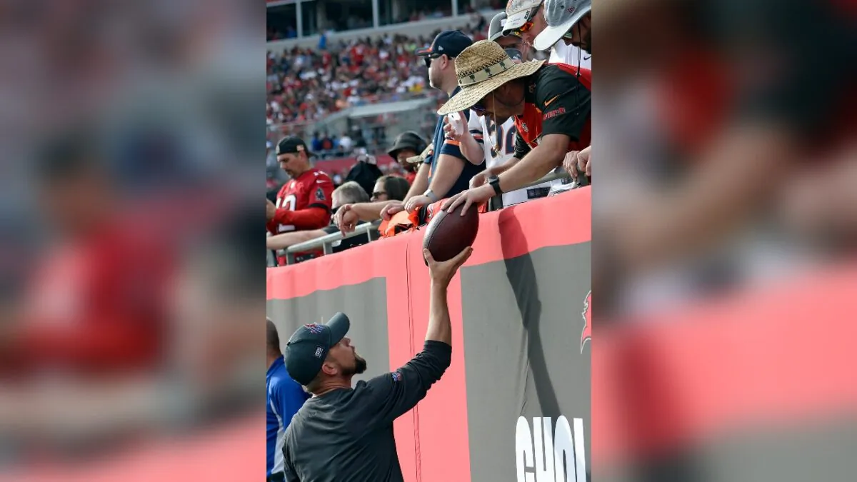 A Tampa Bay Buccaneers fan gives quarterback Tom Brady's 600th career touchdown pass back after wide receiver Mike Evans threw the ball to the fan during the first half of an NFL football game against the Chicago Bears in Tampa, Fla., on Oct. 24, 2021. (Jason Behnken/AP Photo)