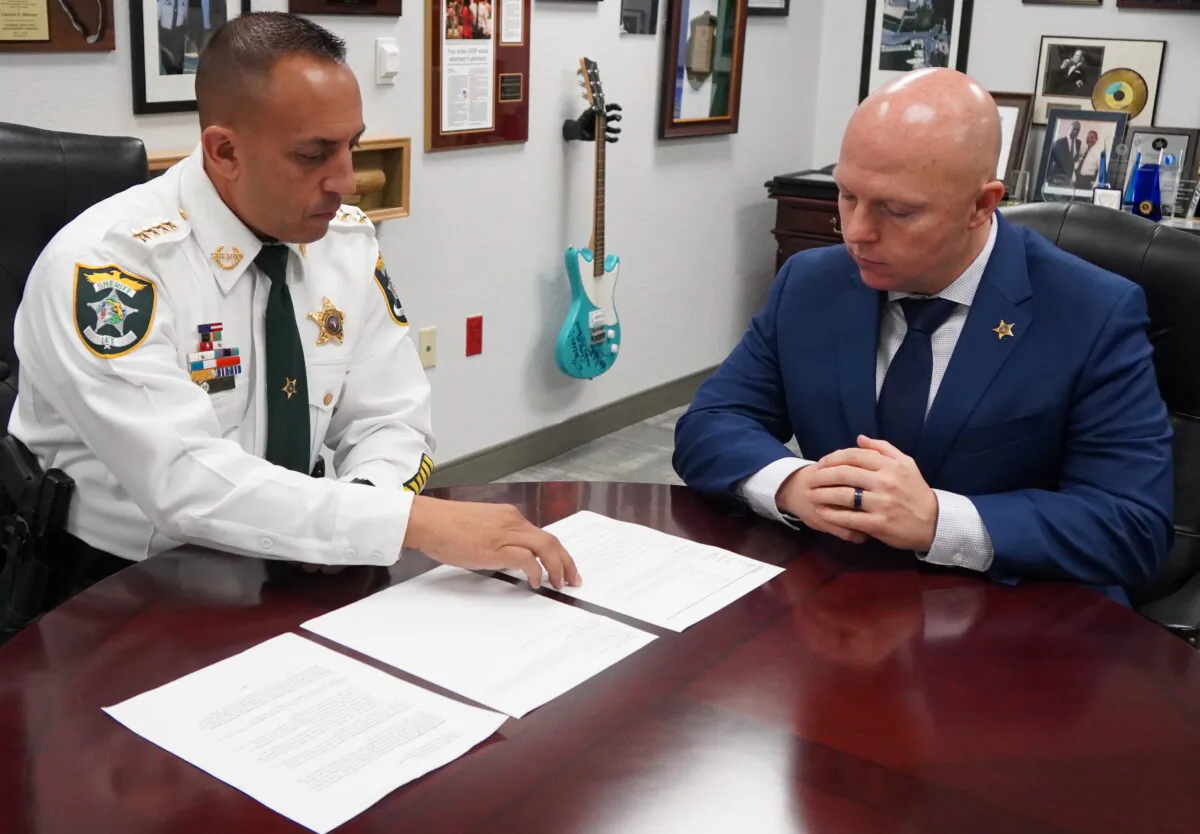 Lee County Sheriff Carmine Marceno (L) discusses reports with Major Christopher Lalor on Sept. 15, 2021. (Jann Falkenstern/Epoch Times)