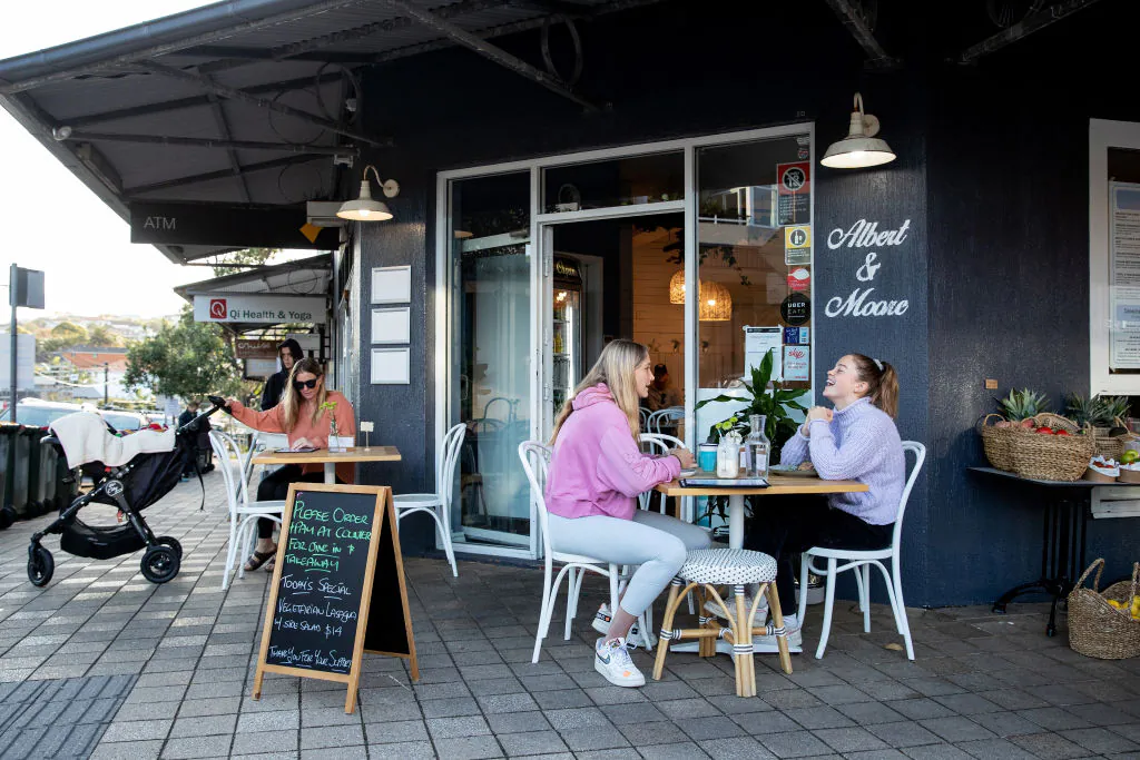 People eat breakfast at a café in Sydney, Australia, on May 15, 2020. (Cameron Spencer/Getty Images)