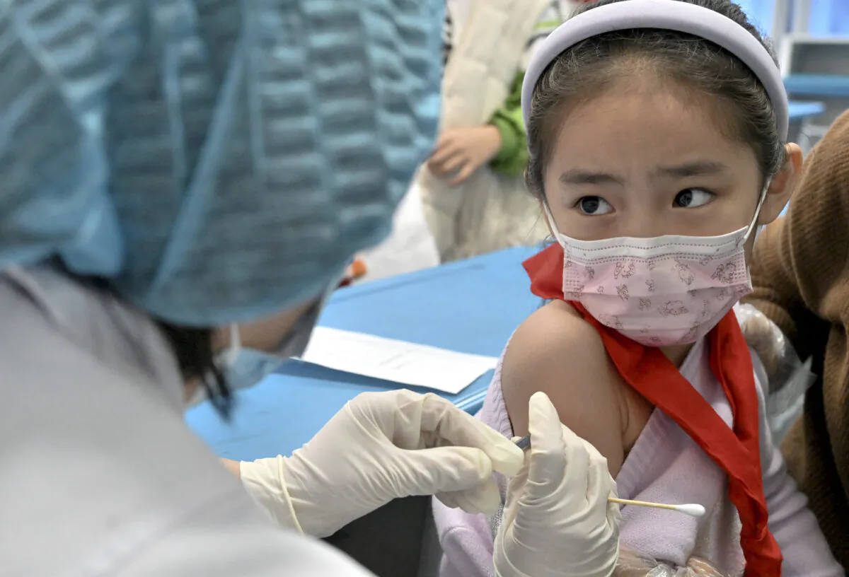 A child receives a COVID-19 coronavirus vaccine at a school in Handan in China's northern Hebei province, on Oct. 27, 2021. (AFP via Getty Images)