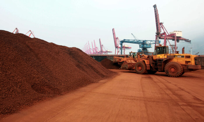 A loader shifts soil containing rare earth minerals to be loaded at a port in Lianyungang, in China's Jiangsu Province, for export to Japan. China controls the world’s supply of rare earth minerals. (STR/AFP via Getty Images)