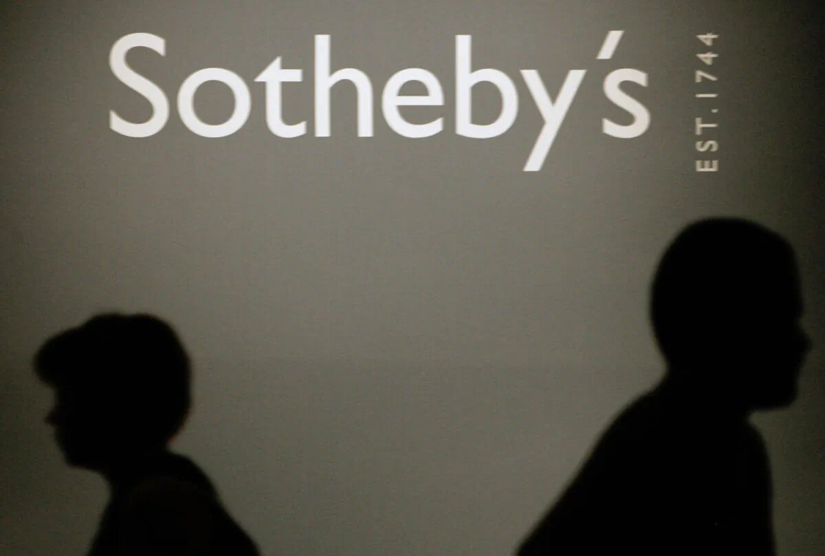 In this file photo, people pass by a Sotheby's auction house logo in the Russian History Museum in Moscow, on May 23, 2007. (Maxim Marmur/AFP via Getty Images)