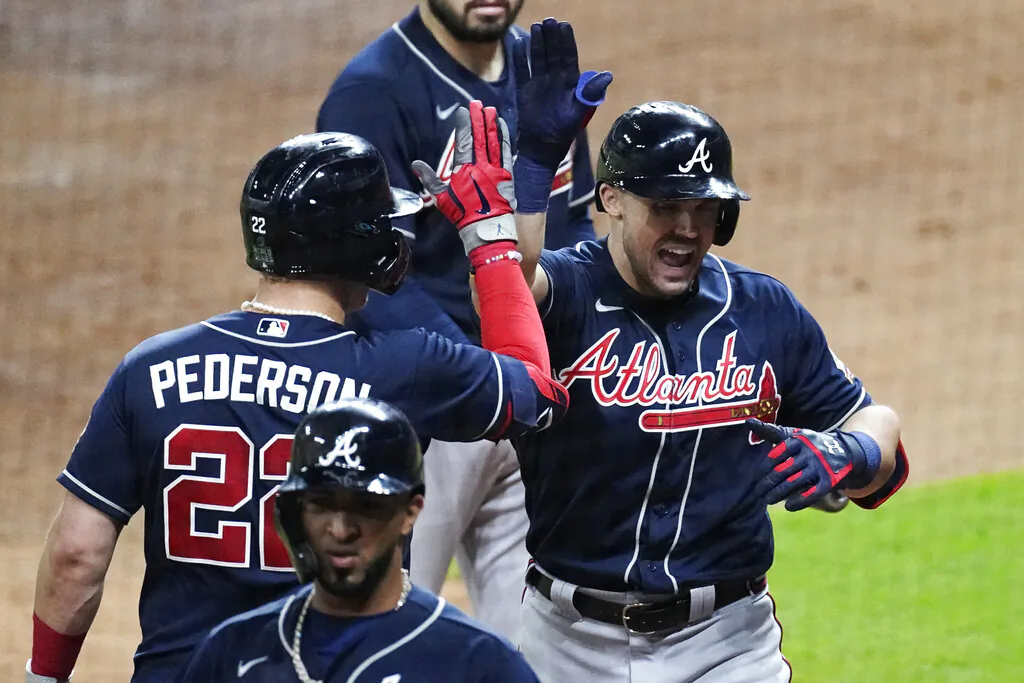 Atlanta Braves' Adam Duvall celebrates his two-run home run with Joc Pederson during the third inning of Game 1 in baseball's World Series between the Houston Astros and the Atlanta Braves Tuesday, Oct. 26, 2021, in Houston. (Eric Gay/AP Photo)