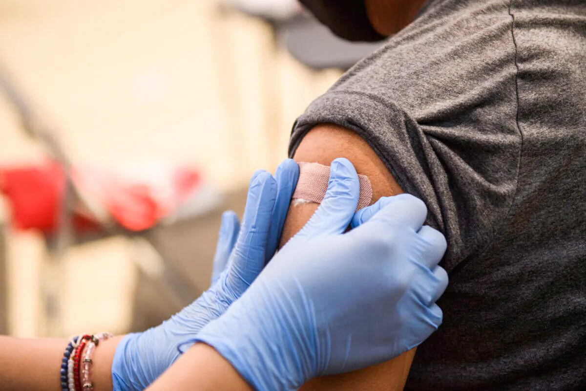 A person receives a bandage after their first dose of the Pfizer COVID-19 vaccine at a clinic in Los Angeles on Aug. 7, 2021. (Patrick T. Fallon/AFP via Getty Images)