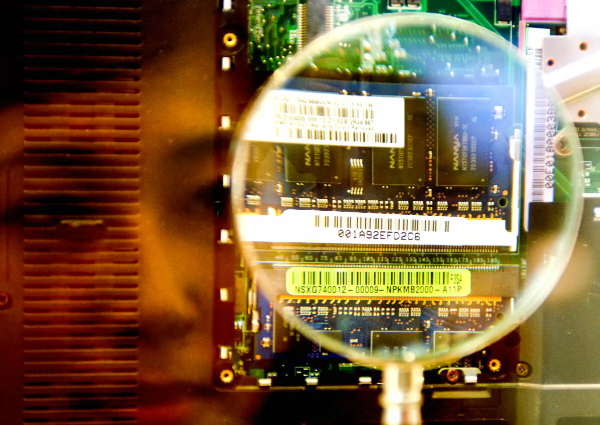 A woman looks through a magnifier to see a 2GB RAM from a notebook during the semi-tech show in Taipei 10 in May 2007.  (Sam Yeh/AFP/Getty Images)