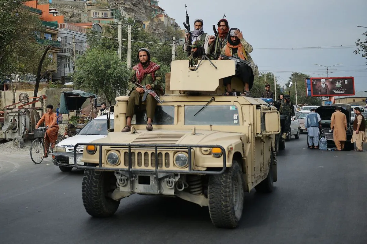 Taliban fighters atop a Humvee vehicle take part in a rally in Kabul, on Aug. 31, 2021. (Hoshang Hashimi/AFP via Getty Images)
