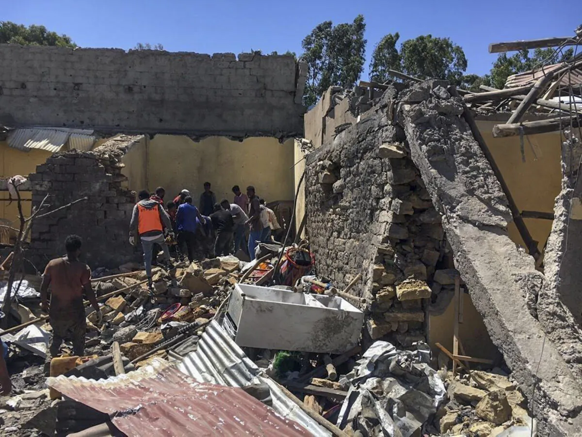 Residents sift through rubble from a destroyed building at the scene of an airstrike in Mekele, in the Tigray region of northern Ethiopia on Oct. 28, 2021. (AP Photo)