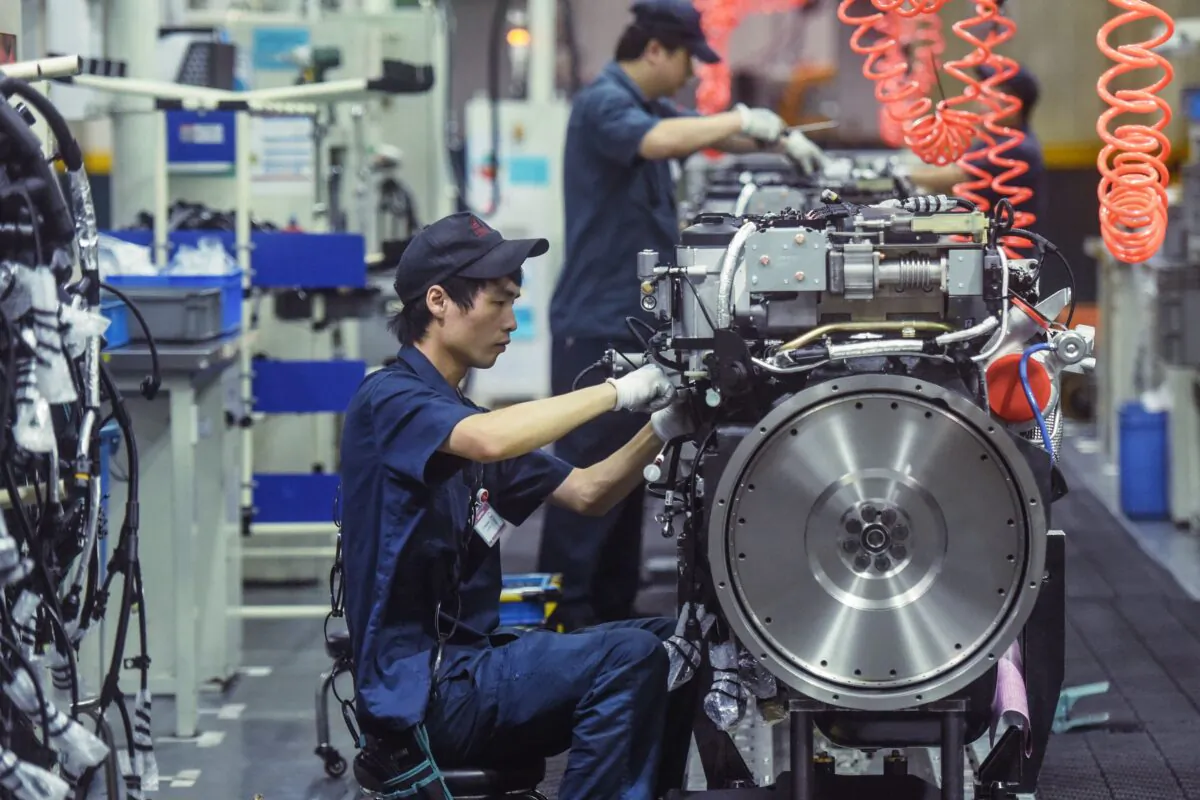 A worker produces heavy truck engines at a factory in Hangzhou, in China's eastern Zhejiang Province on Oct. 18, 2021. (STR/AFP via Getty Images)