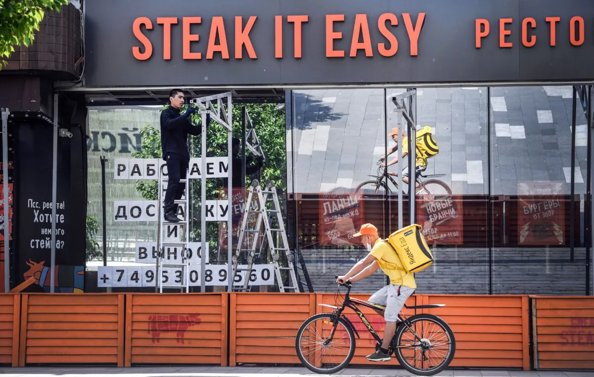 A worker constructs a terrace of a restaurant in central Moscow, Russia, in this file photo taken on June 11, 2020 (Alexander Nemonov/AFP via Getty Images)