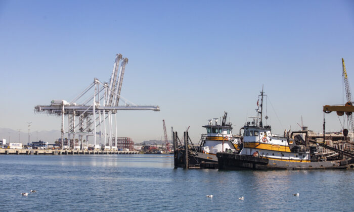 Cargo cranes and tug boats are idle at the Port of Long Beach, Calif., on Oct. 27, 2021. (John Fredricks/  Pezou)