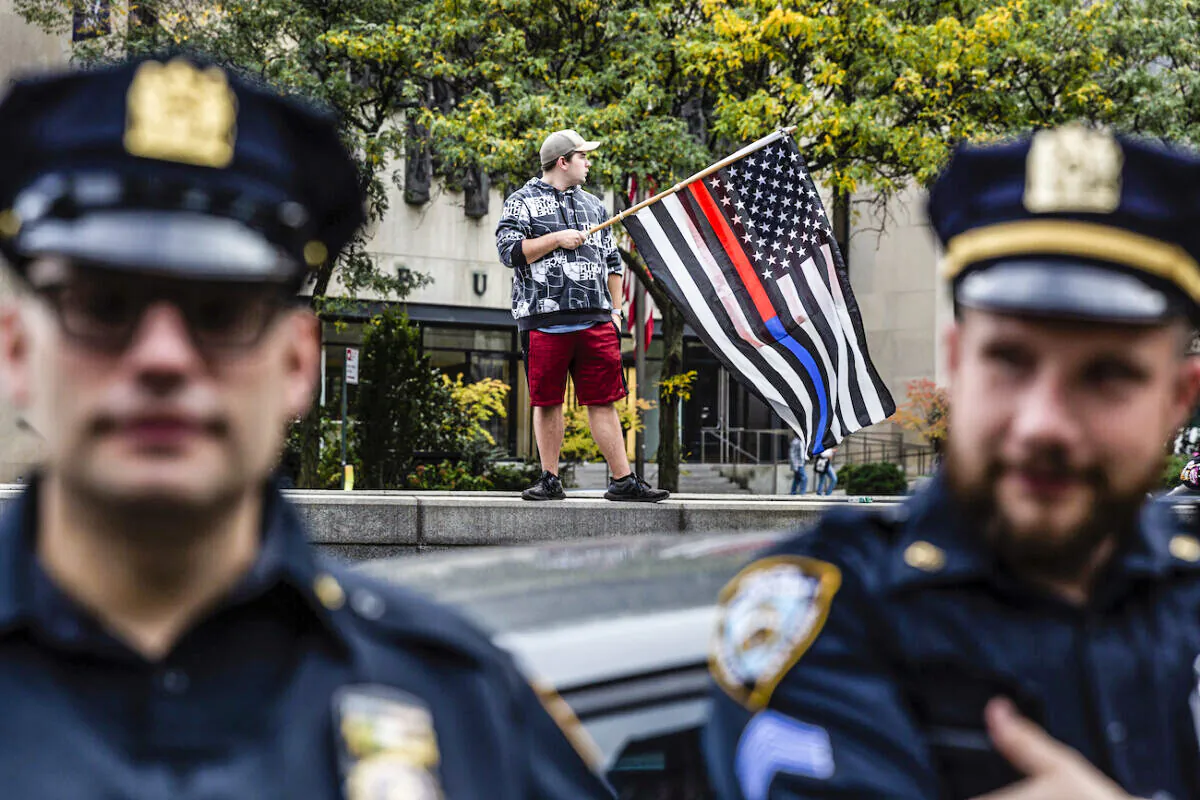New York City municipal workers protest outside City Hall against the coming COVID-19 vaccine mandate in New York, on Oct. 25, 2021. (AP Photo/Timothy Fadek)