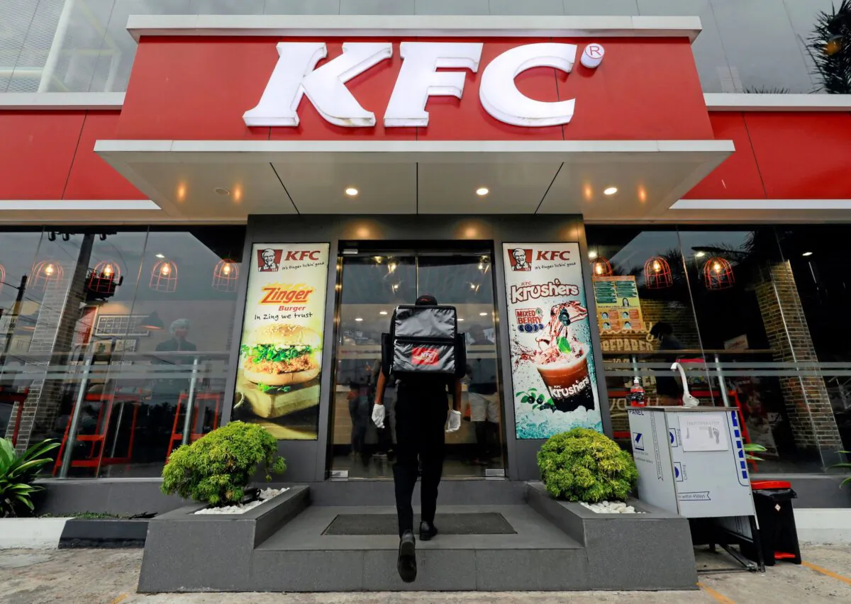 A delivery staff member wearing a protective mask enters a KFC fast food outlet after a delivery, amid concerns about the spread of the coronavirus disease (COVID-19), in Colombo, Sri Lanka on July 9, 2020. (Dinuka Liyanawatt/Reuters)