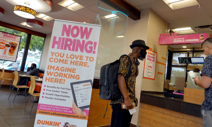 A Now Hiring sign at a Dunkin' restaurant in Hallandale, Fla., on Sept. 21, 2021. (Joe Raedle/Getty Images)