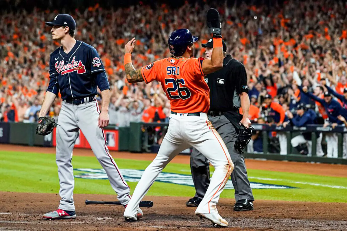 Houston Astros' Jose Siri celebrates past Atlanta Braves starting pitcher Max Fried on a throwing error during the second inning in Game 2 of baseball's World Series between the Houston Astros and the Atlanta Braves in Houston, Texas, on Oct. 27, 2021. (Eric Gay/AP Photo)
