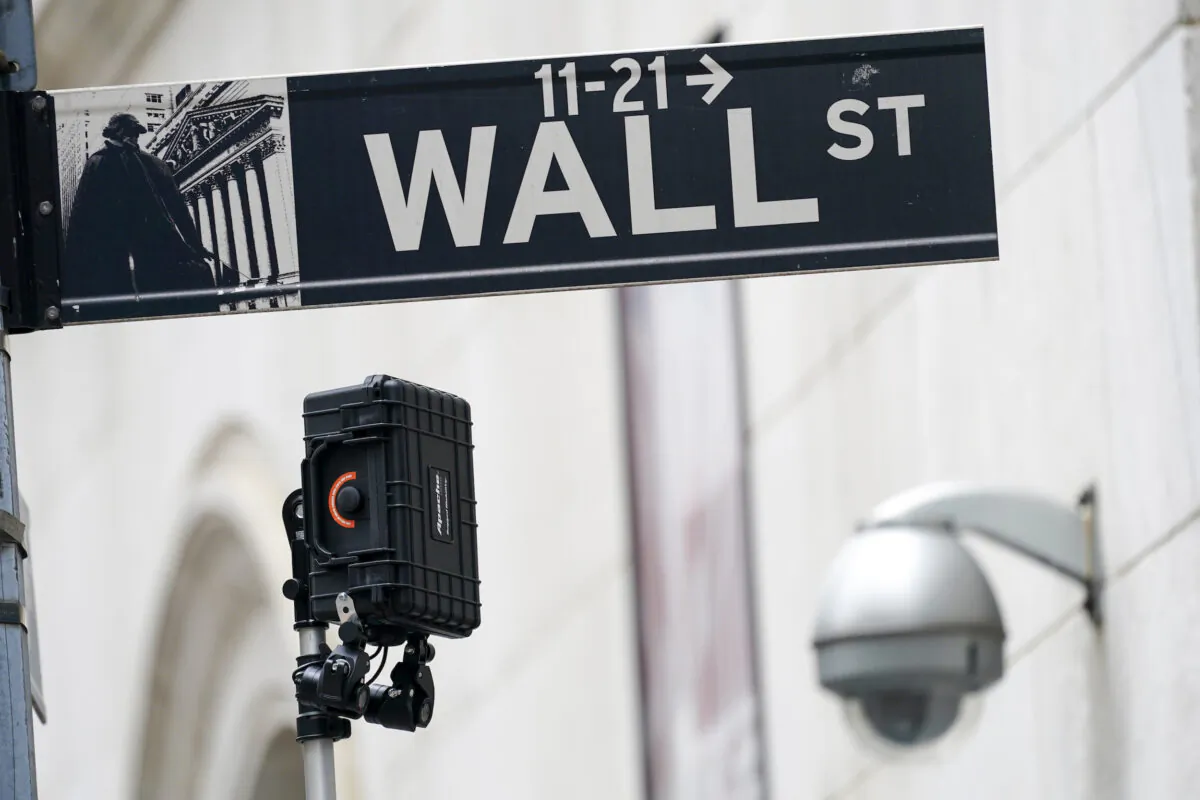 A Wall Street sign is seen next to surveillance equipment outside the New York Stock Exchange in New York, on Oct. 5, 2021. (Mary Altaffer/AP Photo)