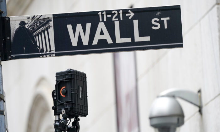A Wall Street sign is seen next to surveillance equipment outside the New York Stock Exchange in New York, on Oct. 5, 2021. (Mary Altaffer/AP Photo)
