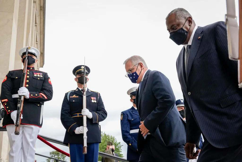 Australian Prime Minister Scott Morrison (L) and U.S. Secretary of Defense Lloyd Austin (R) walk past a military honor guard as they walk inside for a meeting at the Pentagon in Arlington, Virginia, on Sept. 22, 2021. (Drew Angerer/Getty Images)