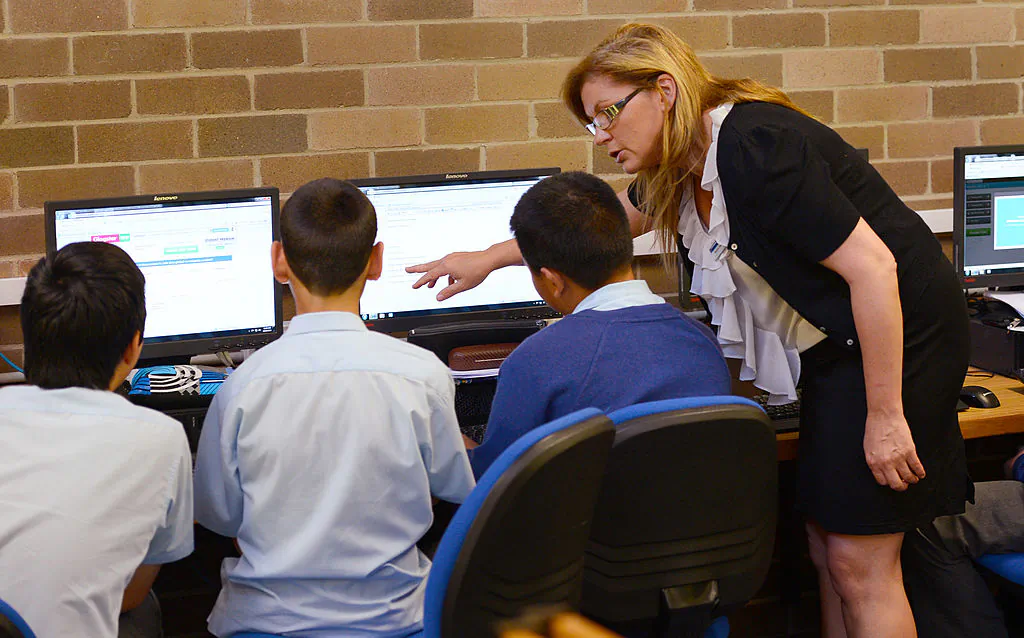 A teacher teaches language to students at St. Johns High School, in Sydney, on Oct. 14, 2012. (William West/AFP via Getty Images)