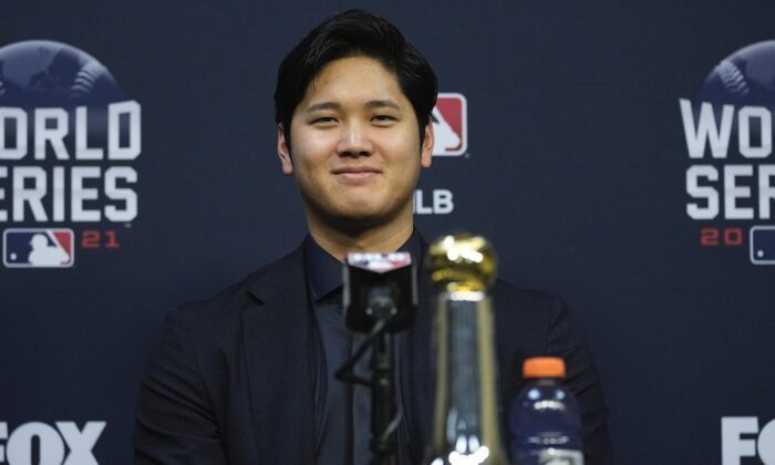 Shohei Ohtani wins the Commissioner’s Historic Achievement Award from Rob Manfred before Game 1 in baseball’s World Series between the Houston Astros and the Atlanta Braves in Houston on Oct. 26, 2021. (AP Photo/Ashley Landis)