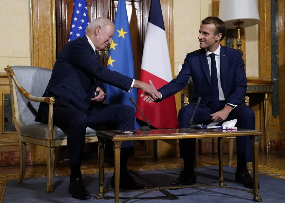 President Joe Biden (L) shakes hands with French President Emmanuel Macron during a meeting at La Villa Bonaparte in Rome, Friday, Oct. 29, 2021. A Group of 20 summit scheduled for this weekend in Rome is the first in-person gathering of leaders of the world's biggest economies since the COVID-19 pandemic started. (AP Photo/Evan Vucci)
