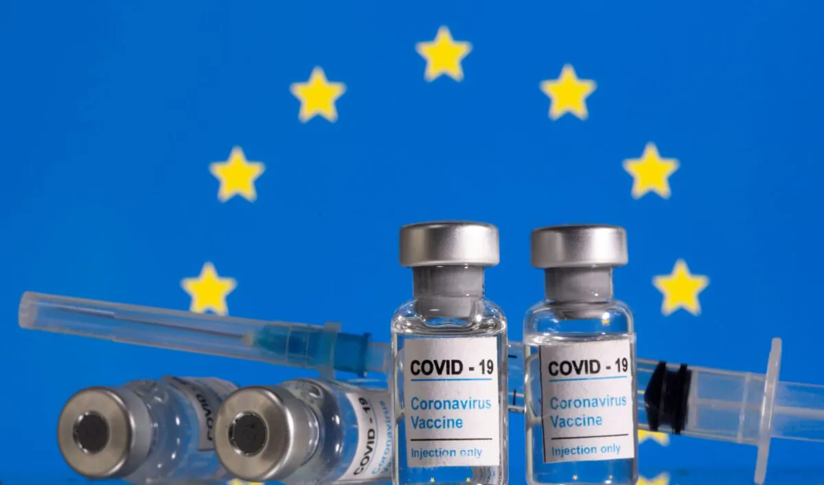 Vials of COVID-19  vaccine and syringes are seen in front of a displayed EU flag in this illustration taken on Feb. 9, 2021. (Dado Ruvic/Illustration/Reuters)
