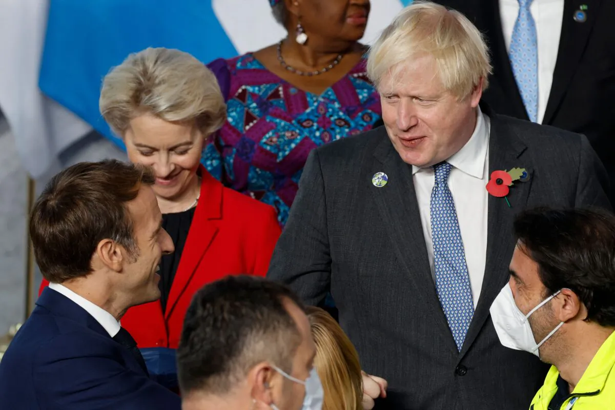 French President Emmanuel Macron (L) gestures as he speaks to British Prime Minister Boris Johnson (R) during the G20 Summit in Rome on Oct. 30, 2021. (Ludovic Marin/AFP via Getty Images)