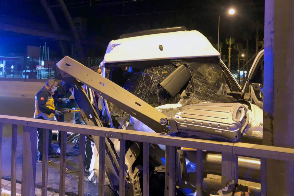 Turkish officials investigate after a minibus crashed near Aksu, in Antalya, Turkey, Oct. 30, 2021. (IHA agency via AP)