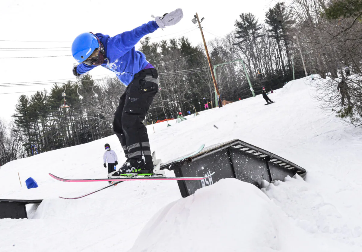 A skier goes off a jump while skiing at the terrain park at Living Memorial Park, in Brattleboro, Vt. Ski, on Feb. 23, 2021. (Kristopher Radder/The Brattleboro Reformer via AP, File)