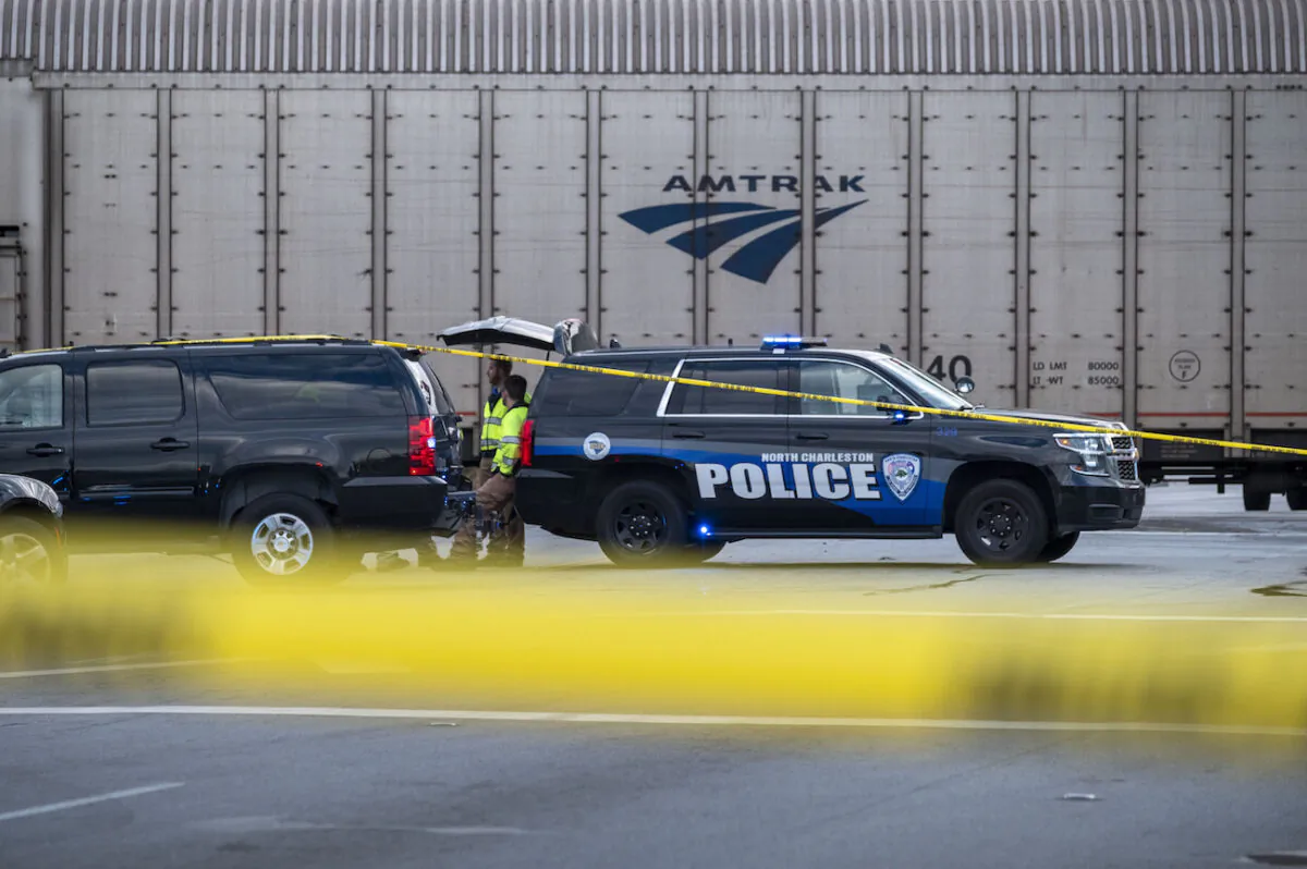 Police work the scene of an early morning collision between a vehicle and a train on Remount Road in North Charleston, S.C. on Oct. 30, 2021. (Matthew Fortner/The Post And Courier via AP)