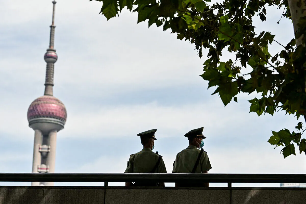 Chinese paramilitary policemen keep watch at the promenade on the Bund along the Huangpu River in Shanghai on Sept. 24, 2021. (Hector Retamal/AFP via Getty Images)