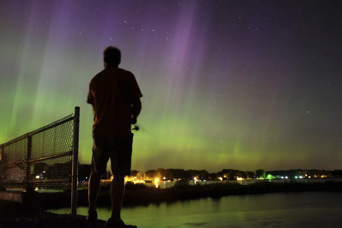 Wade Kitner looks at the northern lights as he fishes in Ventura, Iowa, on June 23, 2015. (Arian Schuessler/The Globe Gazette via AP)