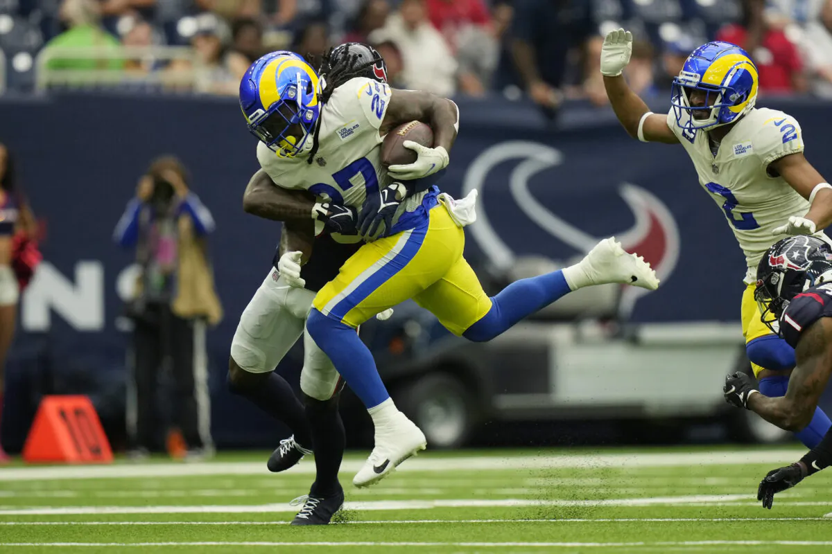 Los Angeles Rams running back Darrell Henderson (27) is hit by Houston Texans cornerback Terrance Mitchell (39) on a run during the first half of an NFL football game in Houston on Oct. 31, 2021. (AP Photo/Eric Smith)