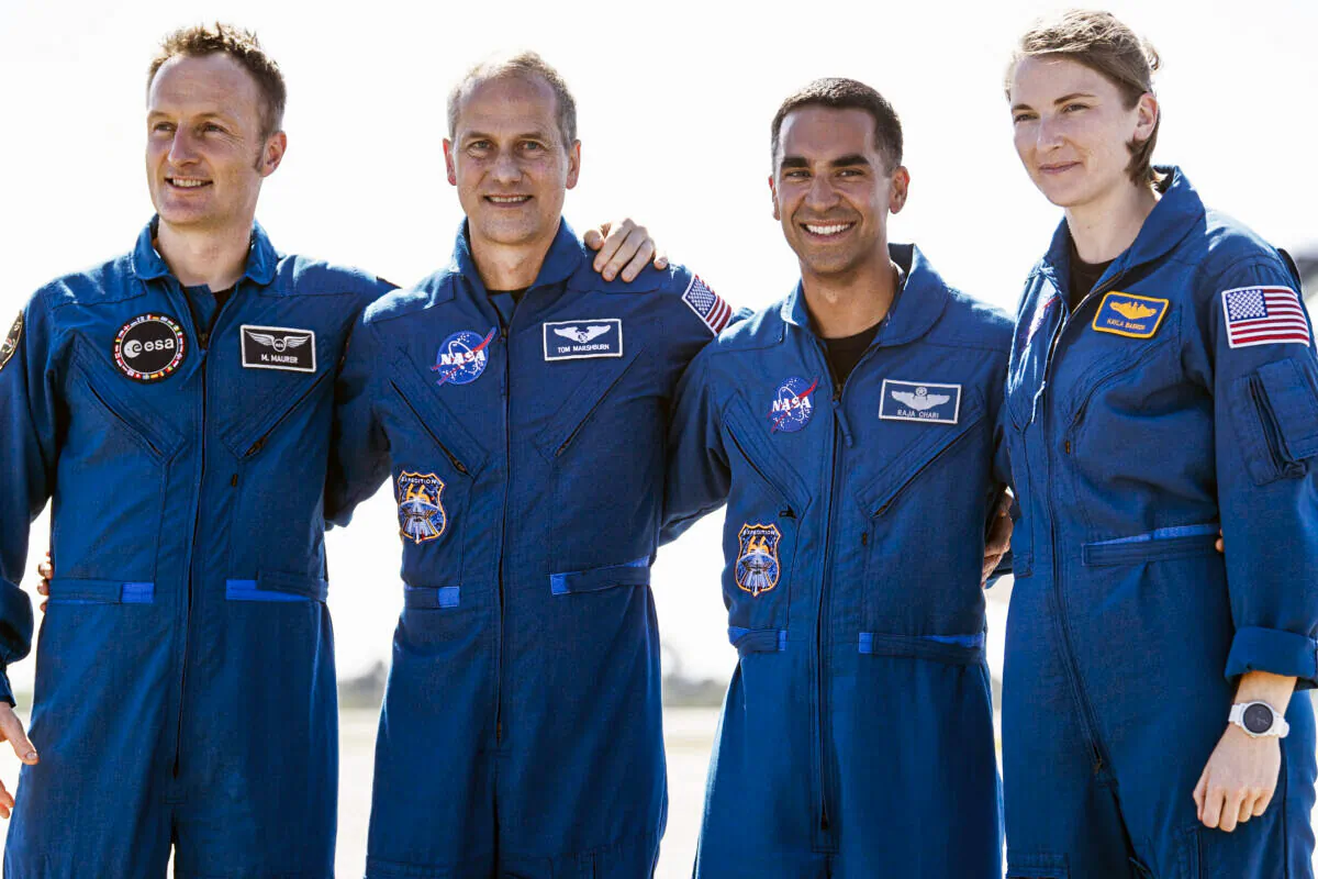 From left, European Space Agency astronaut Matthias Maurer of Germany, and NASA astronauts Tom Marshburn, Raja Chari, and Kayla Barron gather for a photo after arriving at the Kennedy Space Center in Cape Canaveral, Fla., Oct. 26, 2021. (Joel Kowsky/NASA via AP)