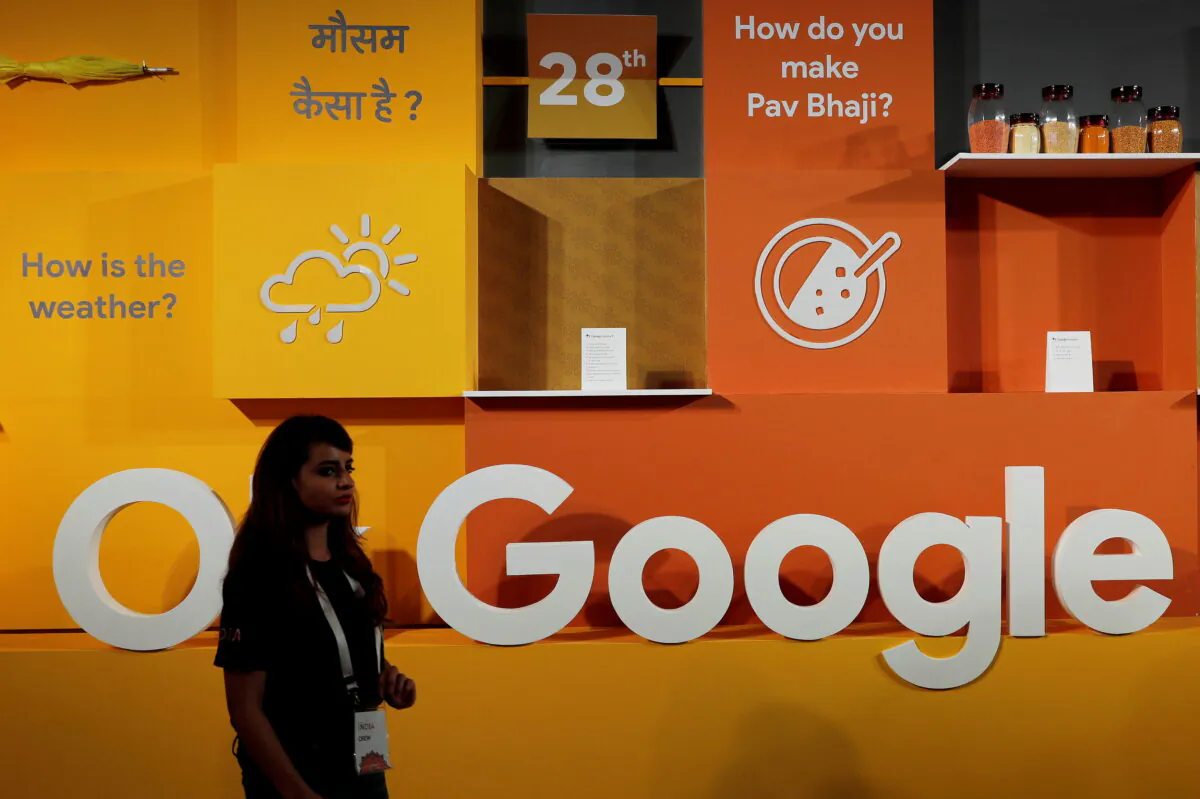 A woman walks past the logo of Google during an event in New Delhi, India, on Aug. 28, 2018. (Adnan Abidi/Reuters)
