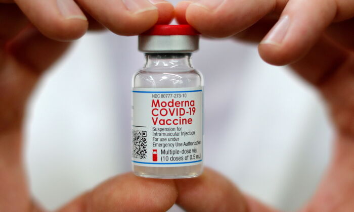 A pharmacist holds a vial of the Moderna COVID-19 vaccine inside a Walmart department store in West Haven, Conn., on Feb. 17, 2021. (Mike Segar/Reuters)