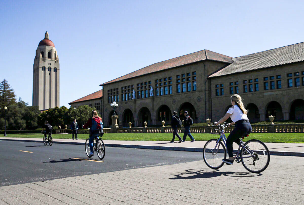 Cyclists ride by Hoover Tower on the Stanford University campus in Stanford, Calif., on March 12, 2019. (Justin Sullivan/Getty Images)
