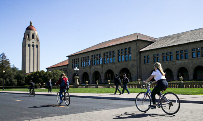 Cyclists ride by Hoover Tower on the Stanford University campus in Stanford, Calif., on March 12, 2019. (Justin Sullivan/Getty Images)