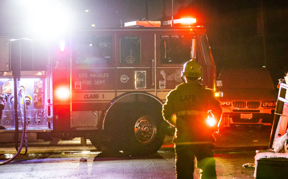 Firefighters with the Los Angeles Fire Department extinguish the flames of a fire in Los Angeles, Calif., on Nov. 6, 2020. (John Fredricks/The Epoch Times)