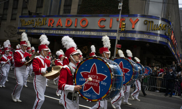 Revelers makes their way down the Avenue of the Americas in front of Radio City Music Hall during the Macy's Thanksgiving Day Parade in New York on Nov. 28, 2019. (Eduardo Munoz Alvarez/AP Photo)