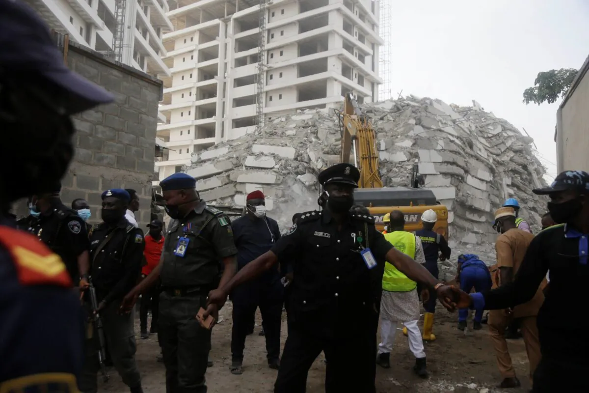 Rescue workers are seen at the site of a collapsed 21-story apartment building under construction in Lagos, Nigeria, on Nov. 1, 2021. (Sunday Alamba/AP Photo)