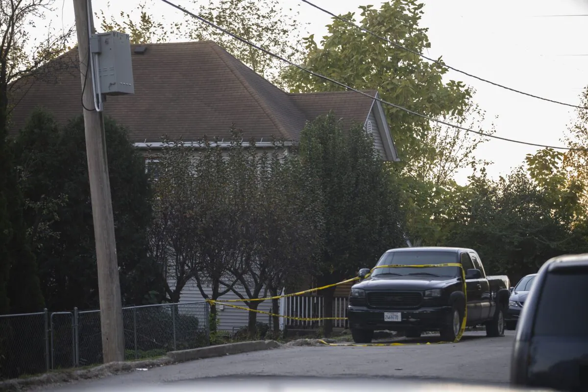 Police tape blocks off access to a fatal shooting at a house in Joliet, Ill., on Oct. 31, 2021. (Anthony Vazquez/Chicago Sun-Times via AP)