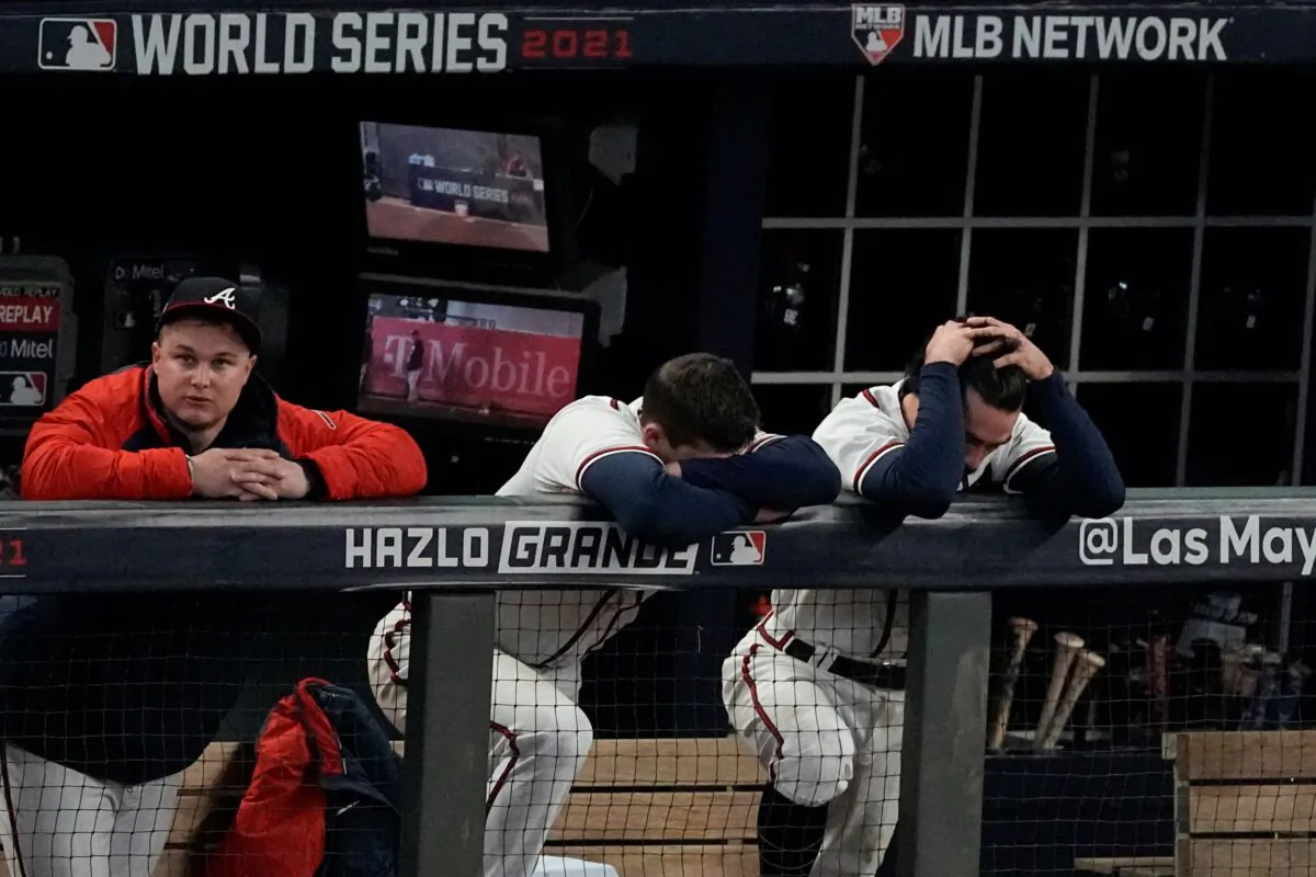 Atlanta Braves right fielder Joc Pederson, from left, third baseman Austin Riley and shortstop Dansby Swanson react during the ninth inning in Game 5 of baseball's World Series between the Houston Astros and the Atlanta Braves in Atlanta, on Nov. 1, 2021. (John Bazemore/AP Photo)