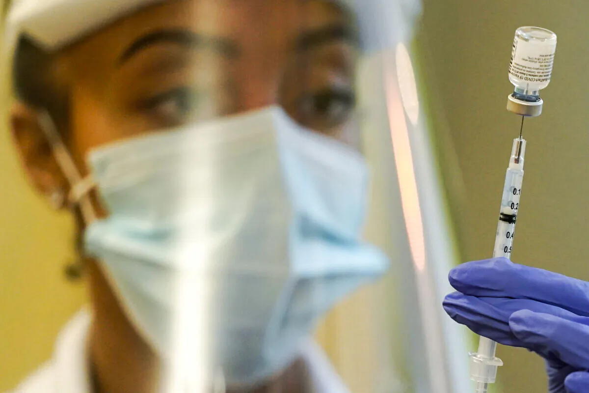 A pharmacist prepares a syringe of the Pfizer vaccine for COVID-19 in Seattle, Wash., on Jan. 8, 2021. (Ted S. Warren/AP Photo)