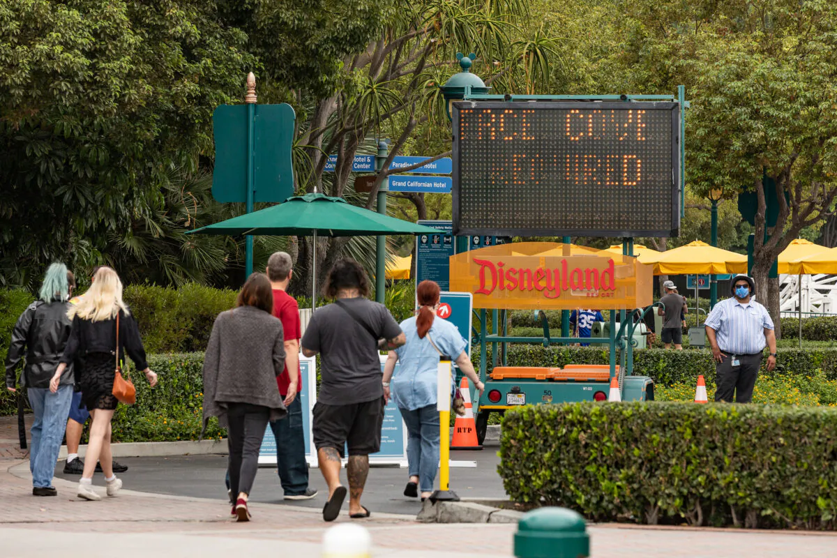 Vistors must go through temperature check stations before entering the Downtown Disney shopping area at Disneyland and California Adventure themeparks in Anaheim, Calif., on Oct. 21, 2020. (John Fredricks/The Epoch Times)