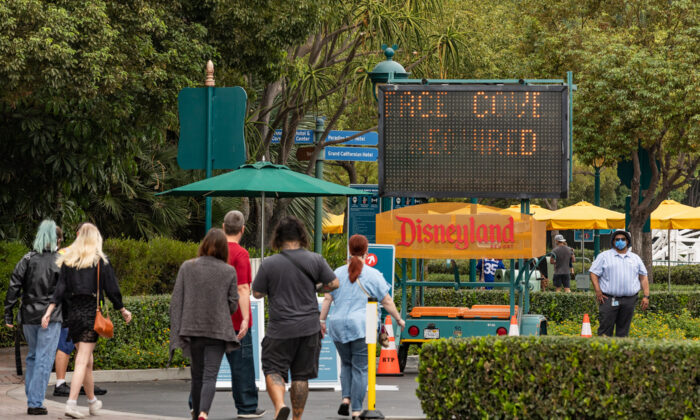 Vistors must go through temperature check stations before entering the Downtown Disney shopping area at Disneyland and California Adventure themeparks in Anaheim, Calif., on Oct. 21, 2020. (John Fredricks/The Epoch Times)
