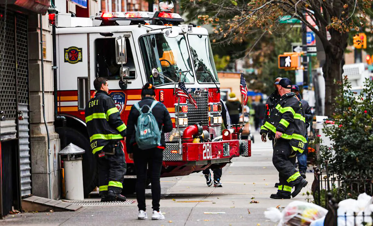 Firefighters watch as their fire engine enters the FDNY Engine 281/Ladder 147 station in the Flatbush neighborhood of Brooklyn borough in New York City on Oct. 29, 2021. (Michael M. Santiago/Getty Images)